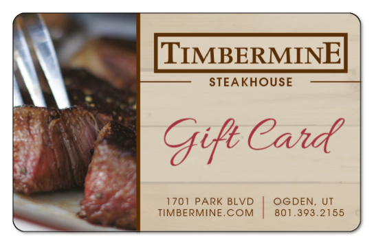 timbermine logo over wooden background, image of fork pressing into steak